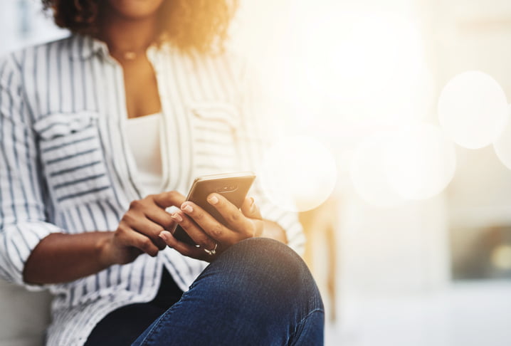 woman typing on phone