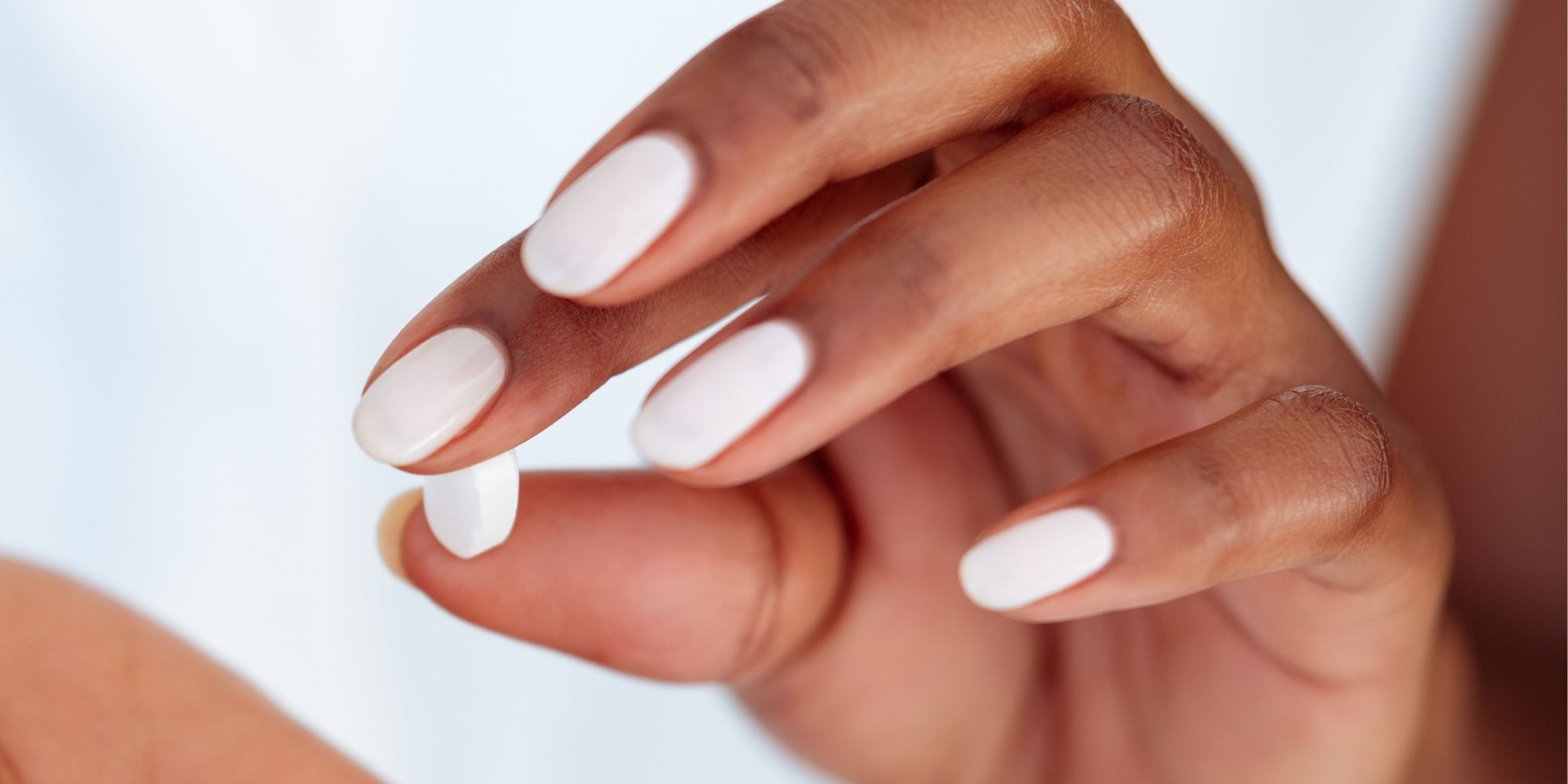 woman holding abortion pill 