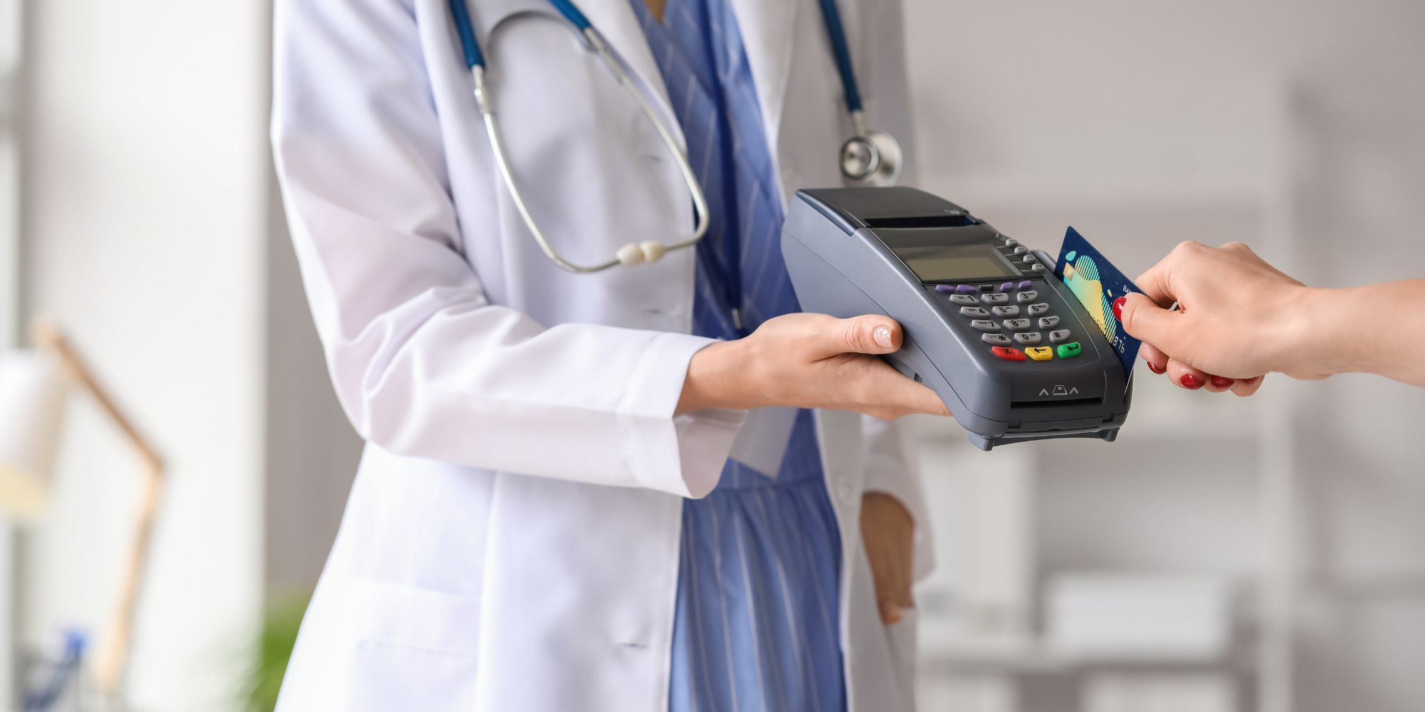 woman paying a fee at doctor's office